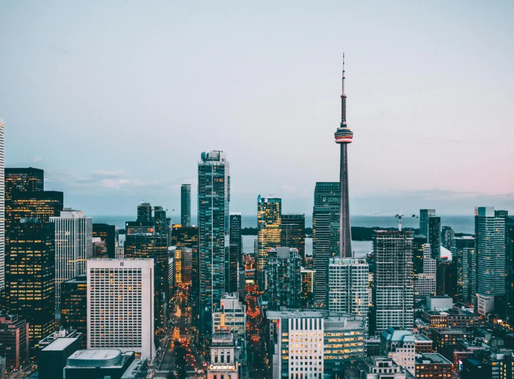 Cityscape of Toronto, with the iconic CN Tower standing tall among the surrounding skyscrapers.